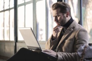 man using a laptop to do finances